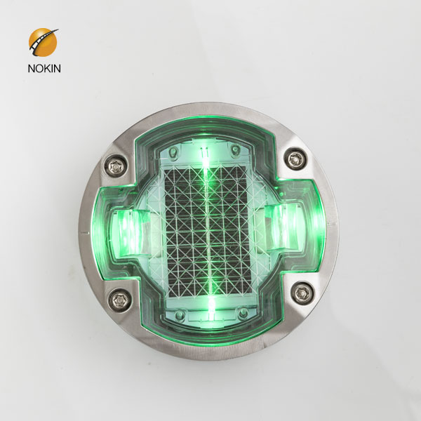 Where on a motorway would you find green reflective studs?